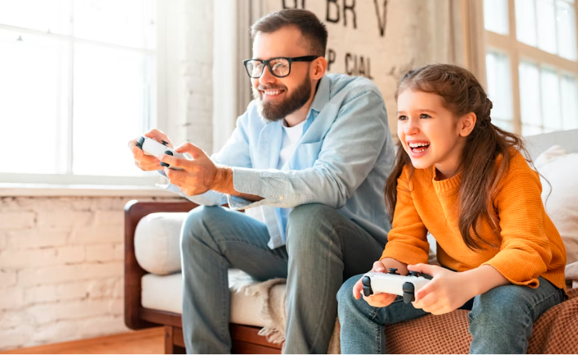 Father and daughter playing PlayStation together at home